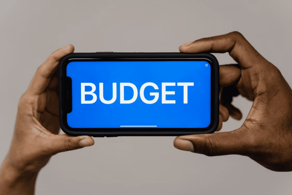 hands holding smartphone budget screen