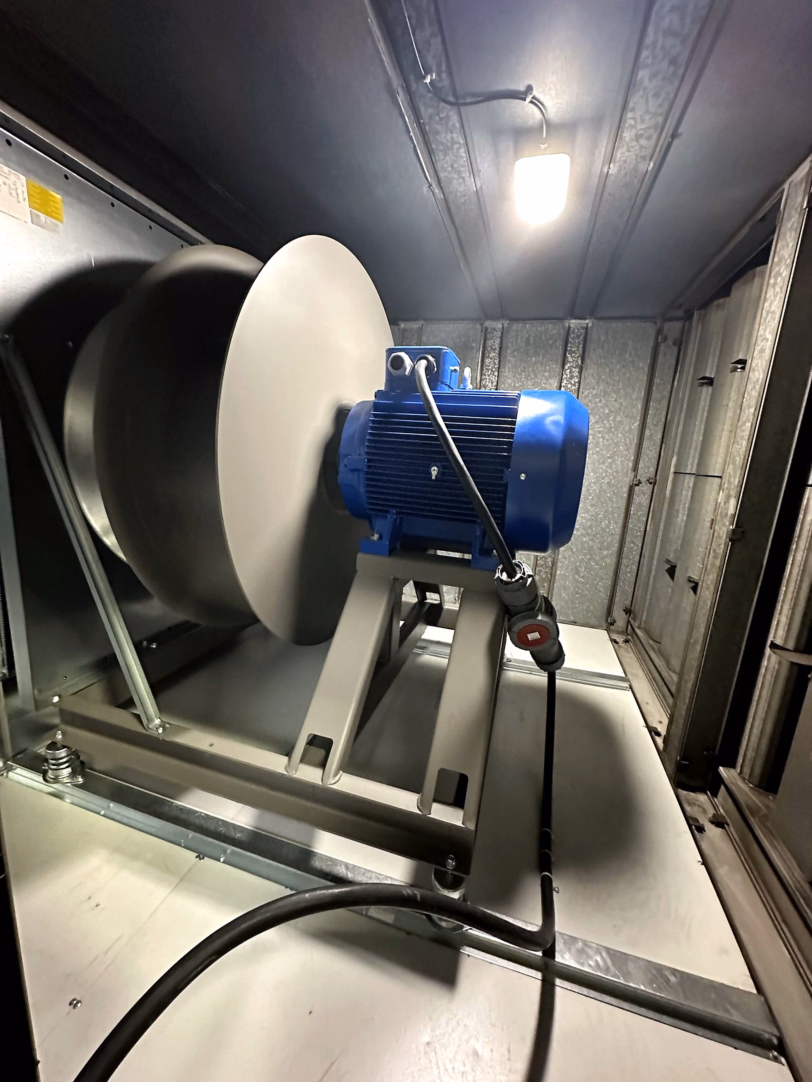 New direct-drive plug fan installed within the AHU casing