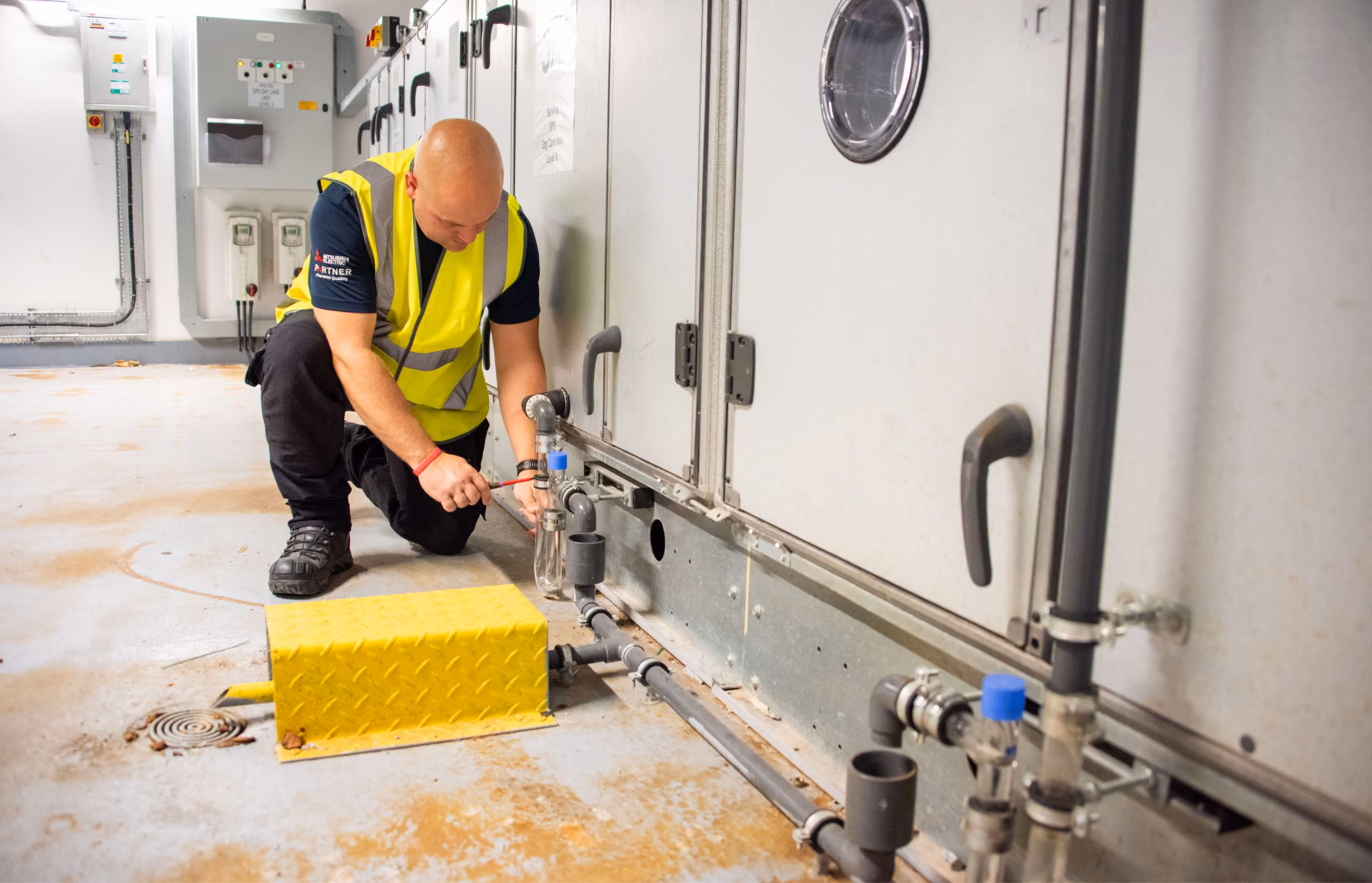 Emtec engineer servicing plant room equipment at a school site