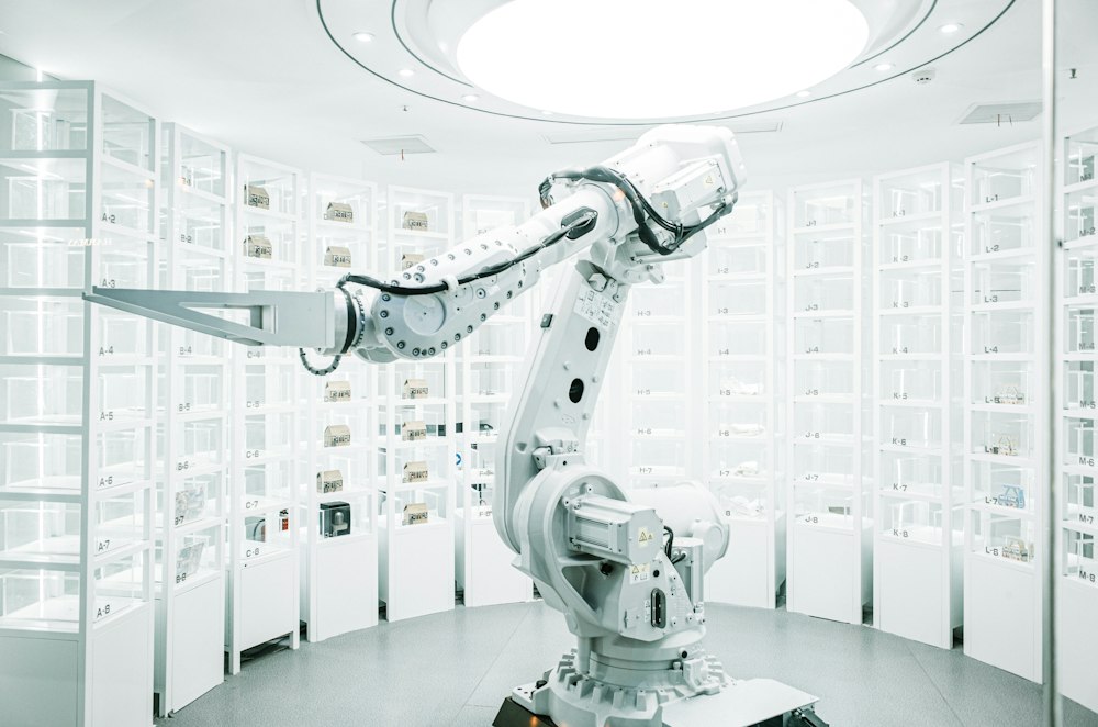 A white industrial robot arm in a bright automation lab