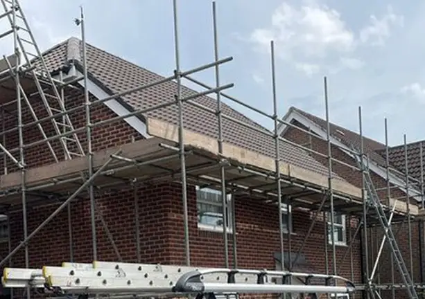 Professional roofing installation with scaffolding on site