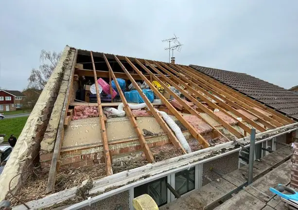 Complete roof strip and replacement showing exposed timber structure