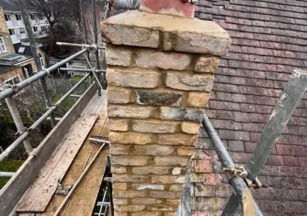 Chimney and gutter maintenance work on tiled roof