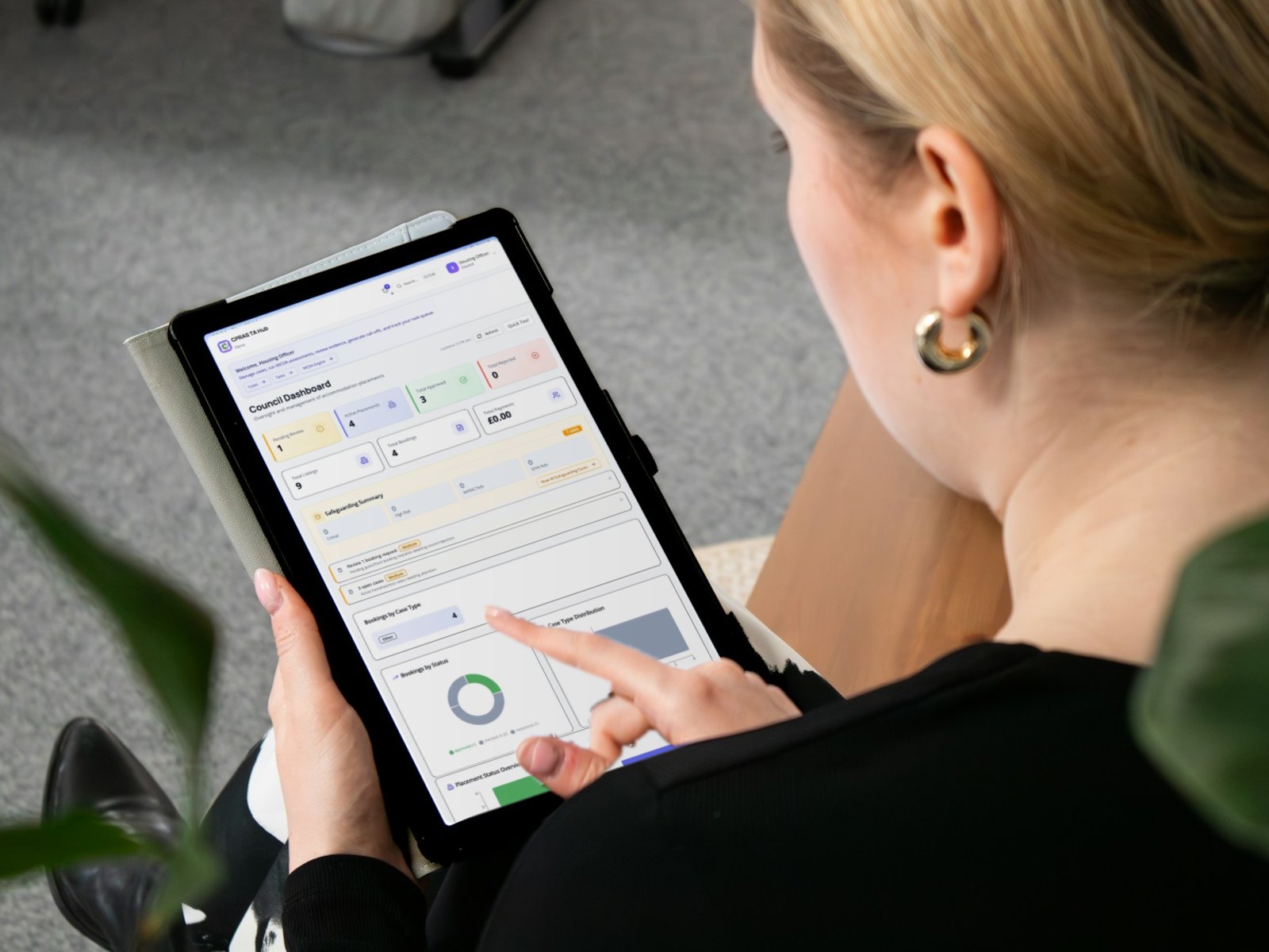 A council officer using the CPRAS TA Hub dashboard on a tablet