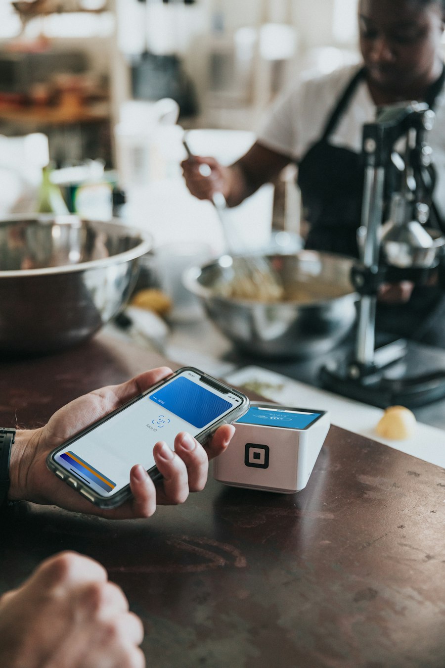 A phone held to a contactless card reader to make a payment