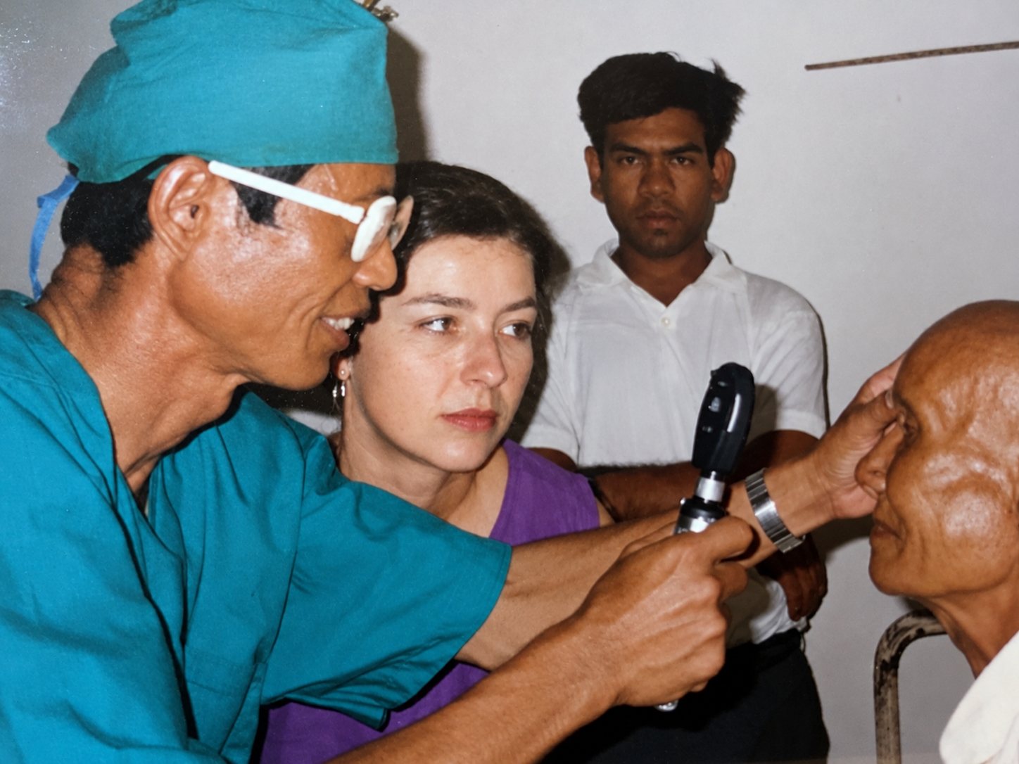 Examining a patient with Cambodian colleagues, Battambang, 1993