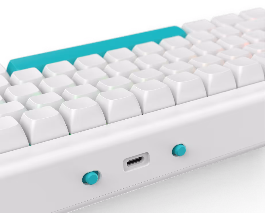 Close-up of a white mechanical keyboard edge with teal keys, two teal buttons, and a USB-C port.