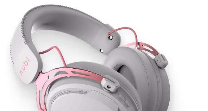 Close-up of gray and pink over-ear headphones with cushioned headband and ear cups.