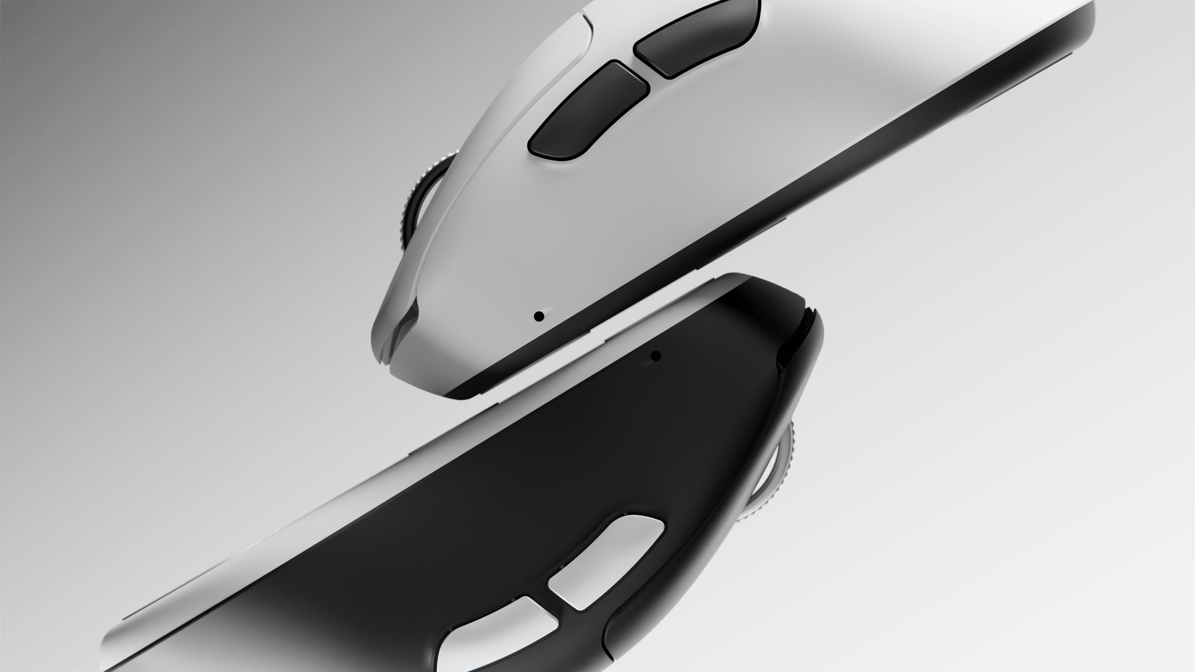 Close-up top view of two computer mice, one white and one black, positioned diagonally with visible side buttons and scroll wheels.