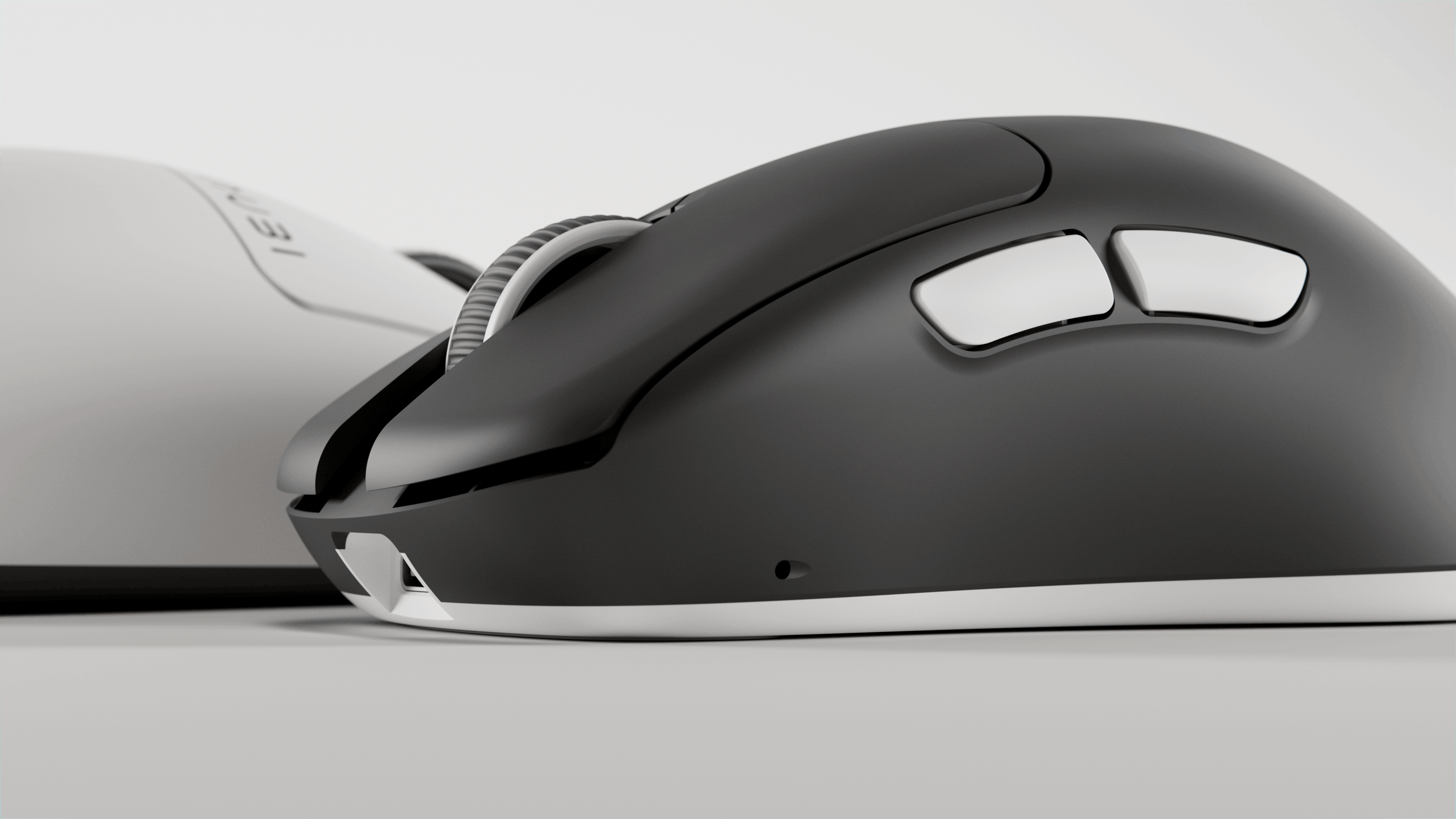 Close-up side view of a black and white computer mouse showing two side buttons and a ribbed scroll wheel.