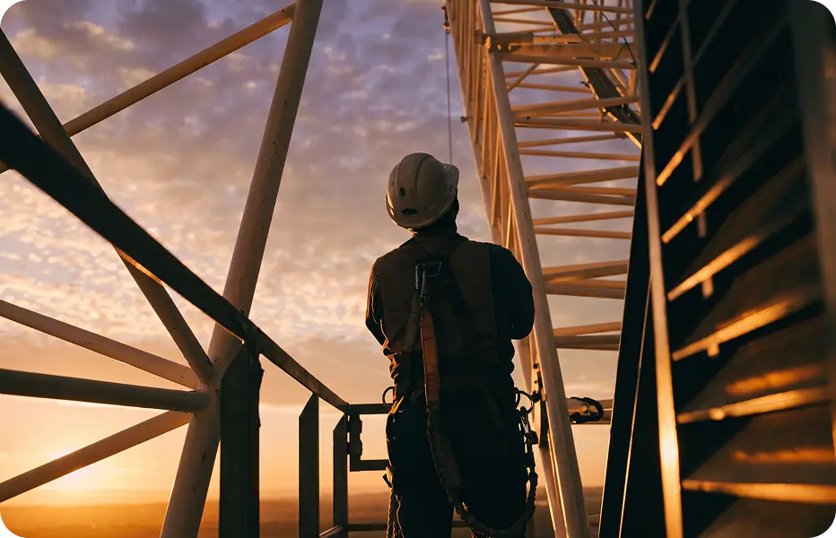 Engineer inspecting plant steelwork at dusk