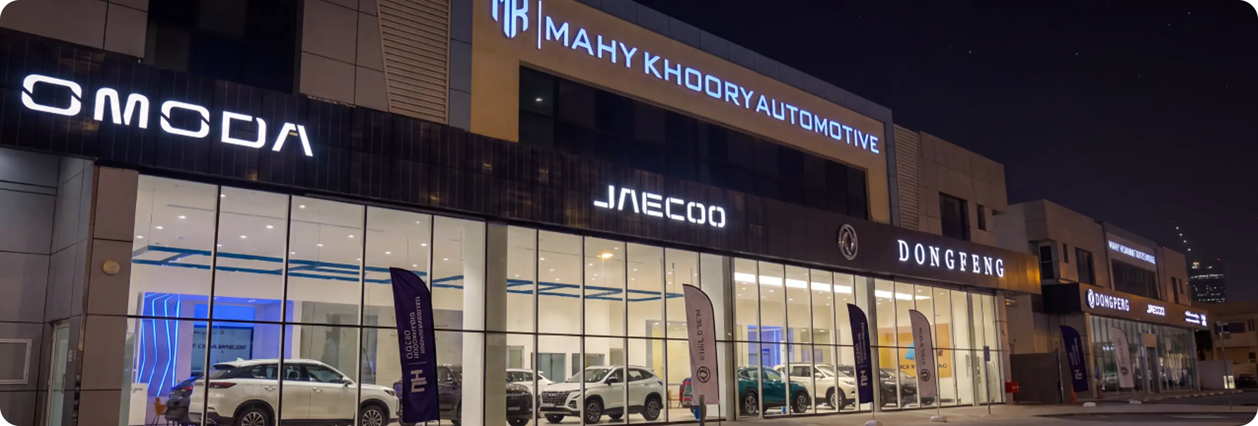 M.A.H.Y. Khoory Automotive showroom for Dongfeng, OMODA and JAECOO at night