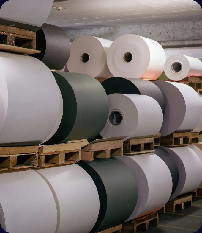 Rolls of recycled containerboard stacked on pallets