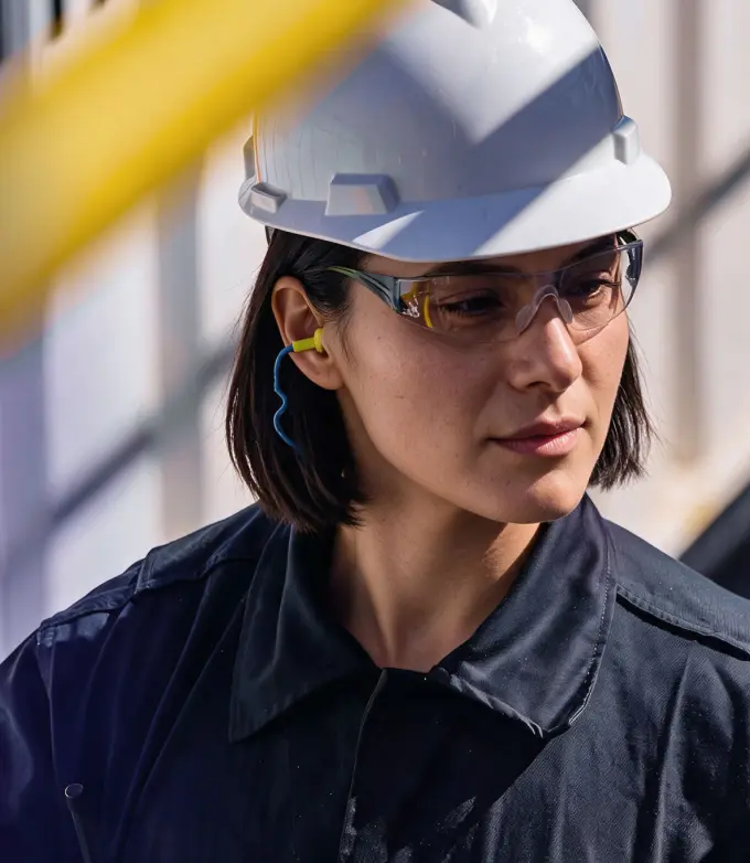 Factory worker in a hard hat and safety glasses
