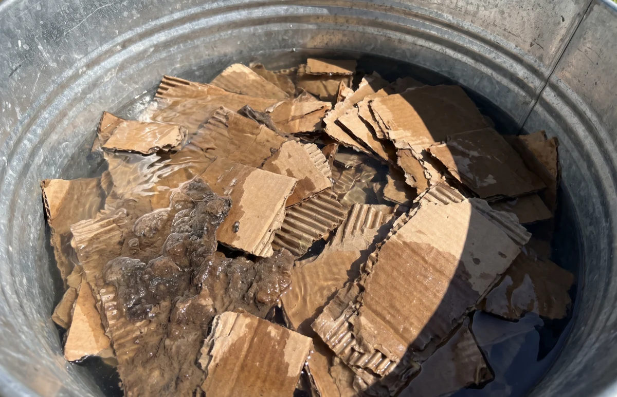 Recovered cardboard waiting to be pulped for fibre treatment