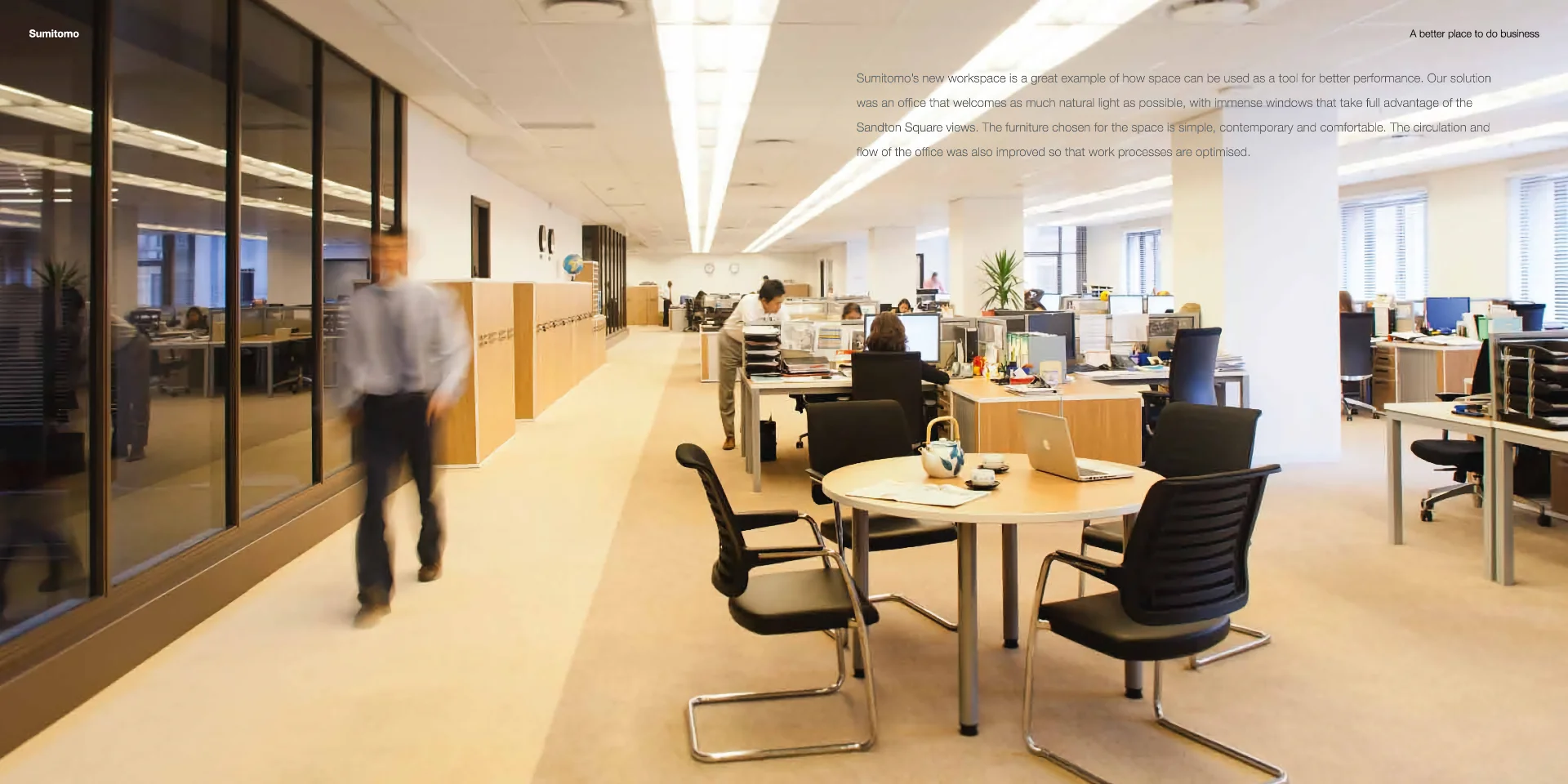 a blurry photo of a man walking through an office