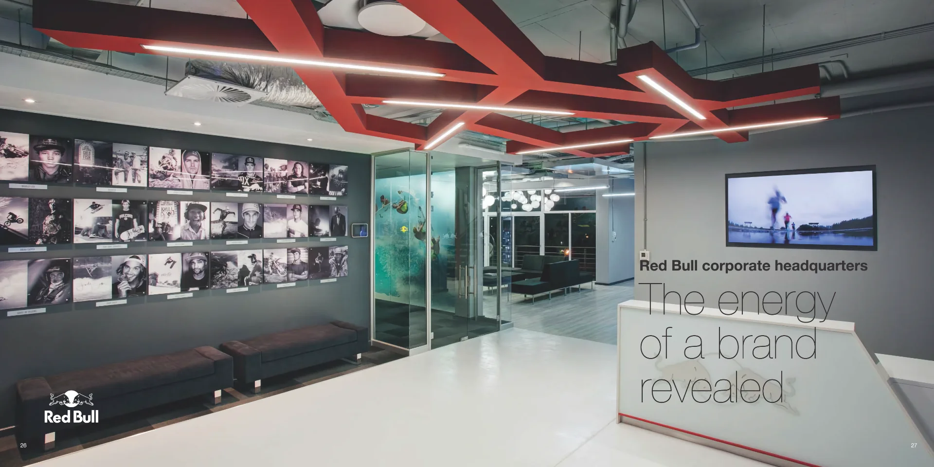an office lobby with a television and a bench