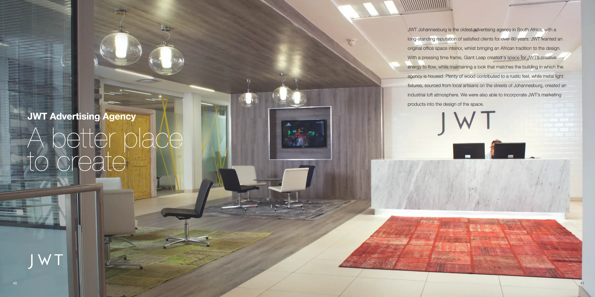 a reception area with a red rug and chairs