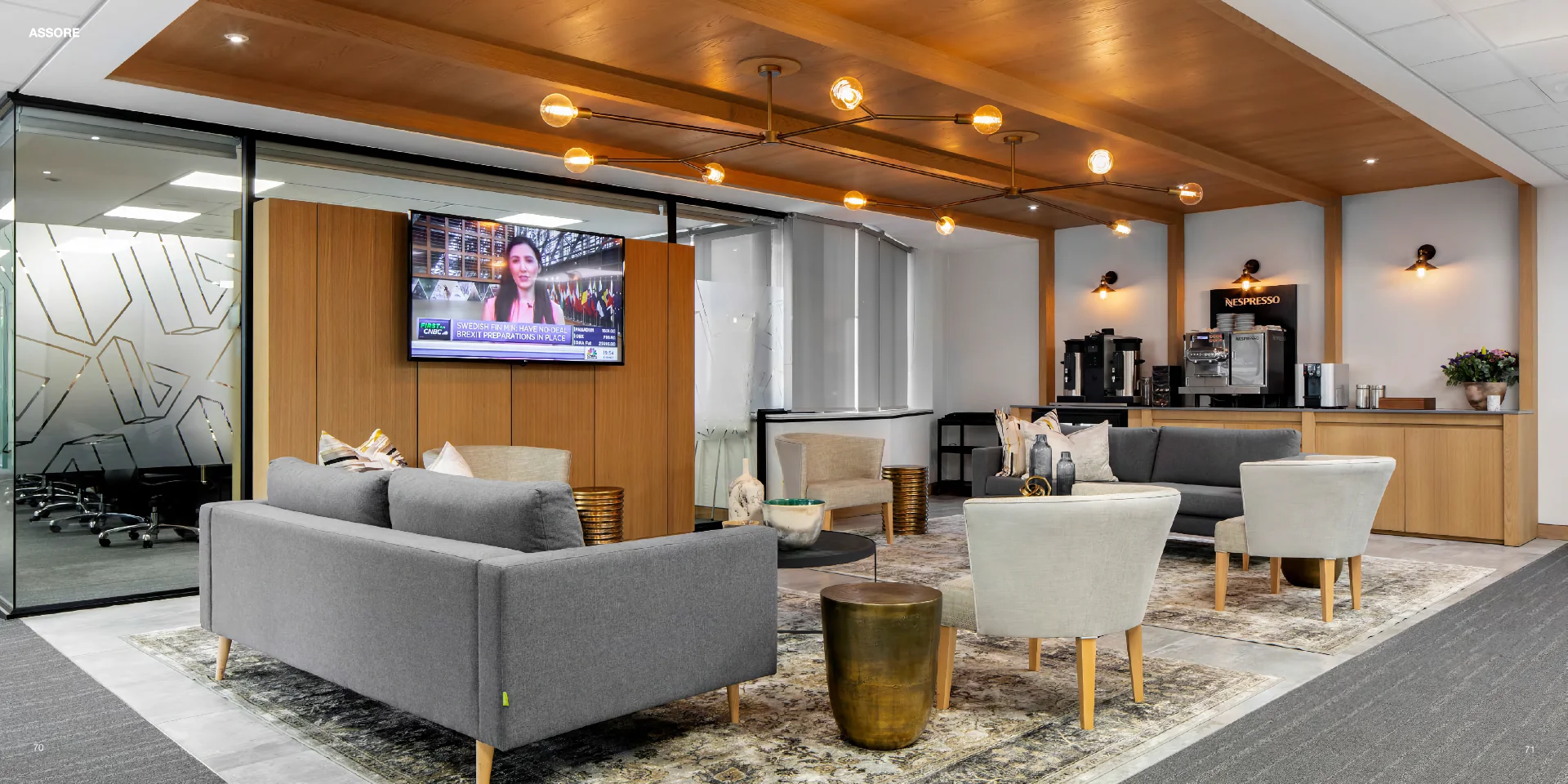 a waiting room filled with furniture and a flat screen tv