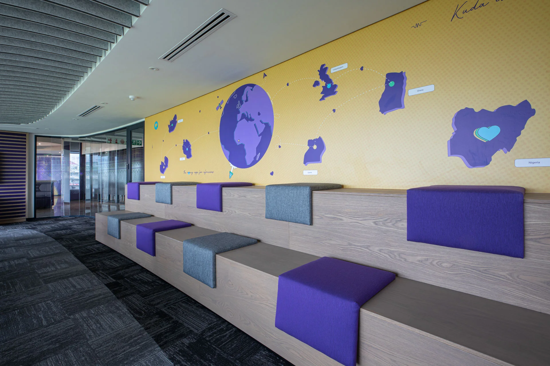 a room with a yellow and purple wall and a bench