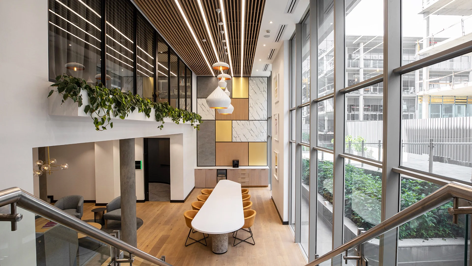 a room with a table, chairs, and a staircase