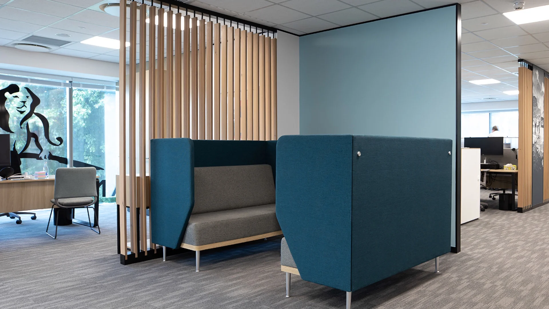 an office cubicle with blue and grey furniture