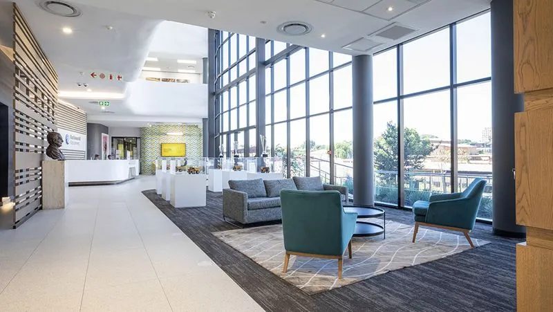 a lobby with a lot of windows and furniture