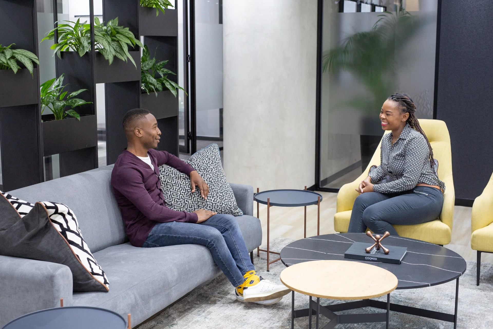a man and a woman sitting on a couch talking