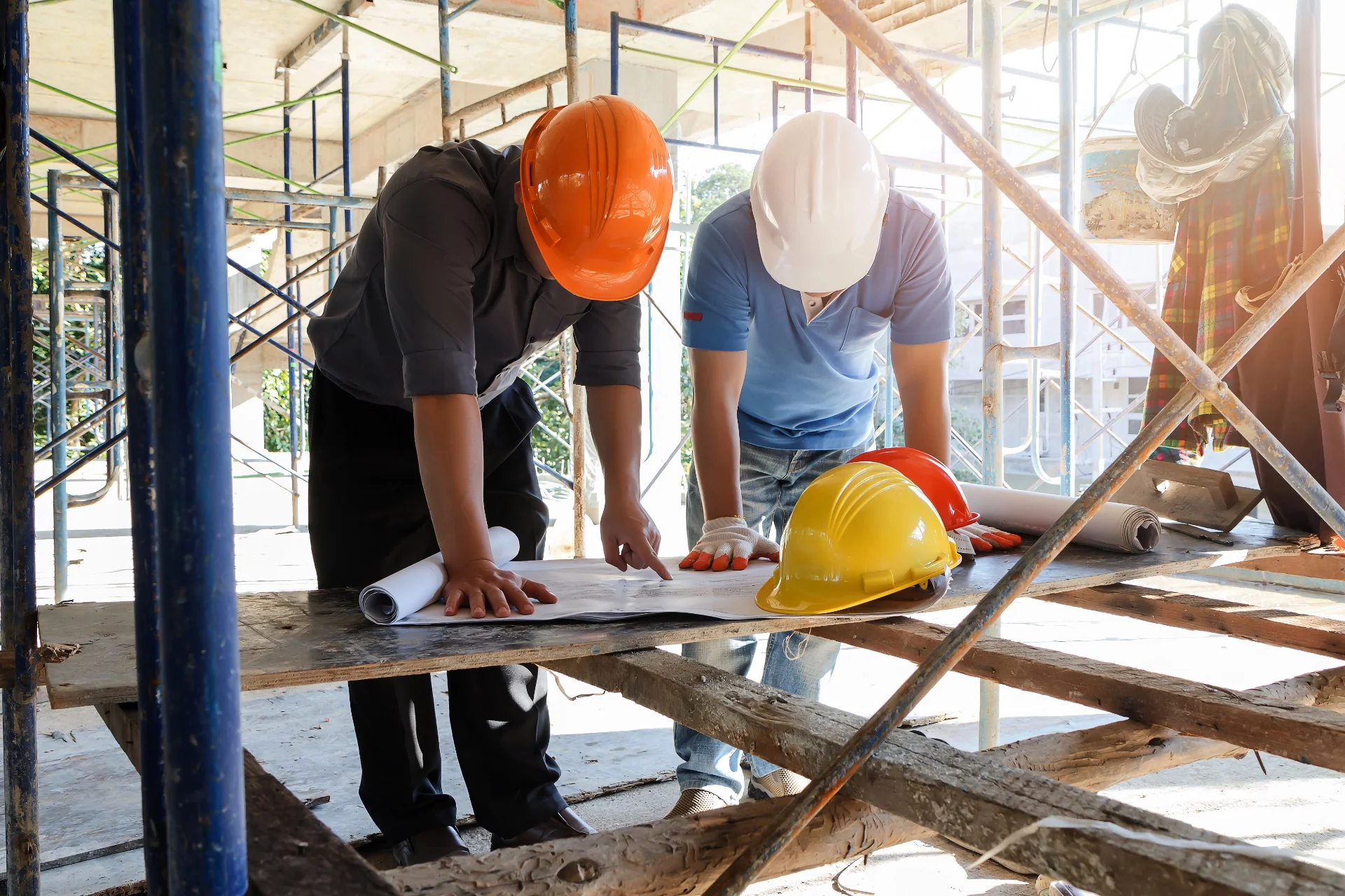 a couple of men standing next to each other on a construction site