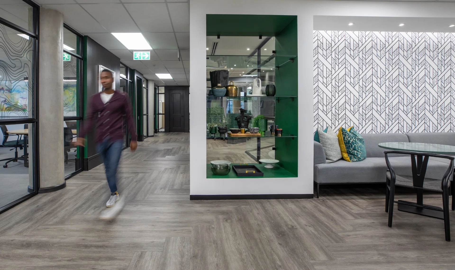 a man walking down a hallway in a building