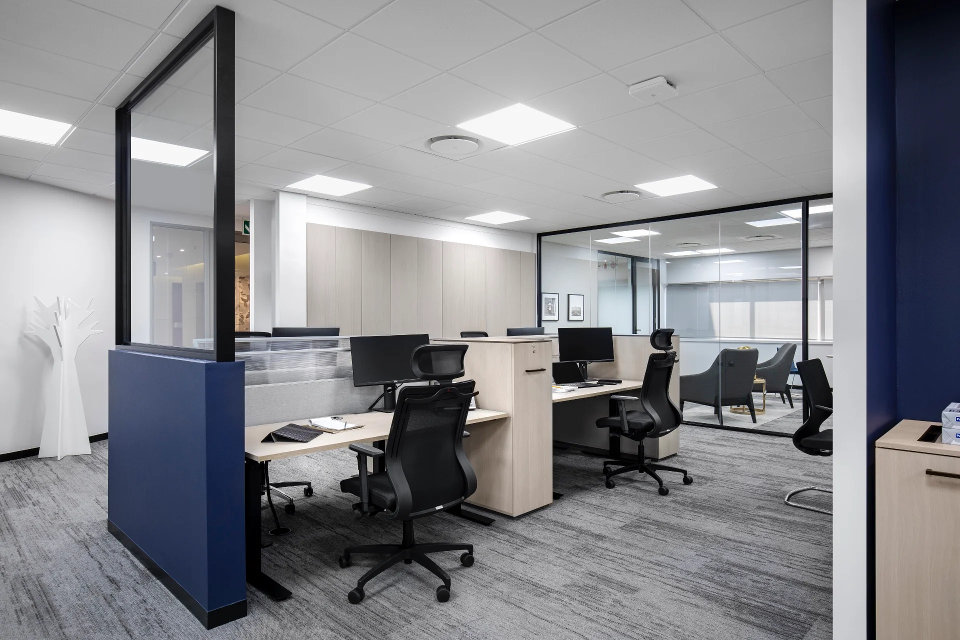 an office cubicle with desks and chairs
