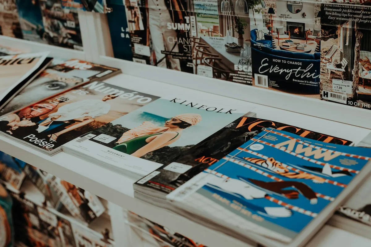 Magazines racked on a shelf, each one overlapping the next so only the top strip of each cover shows