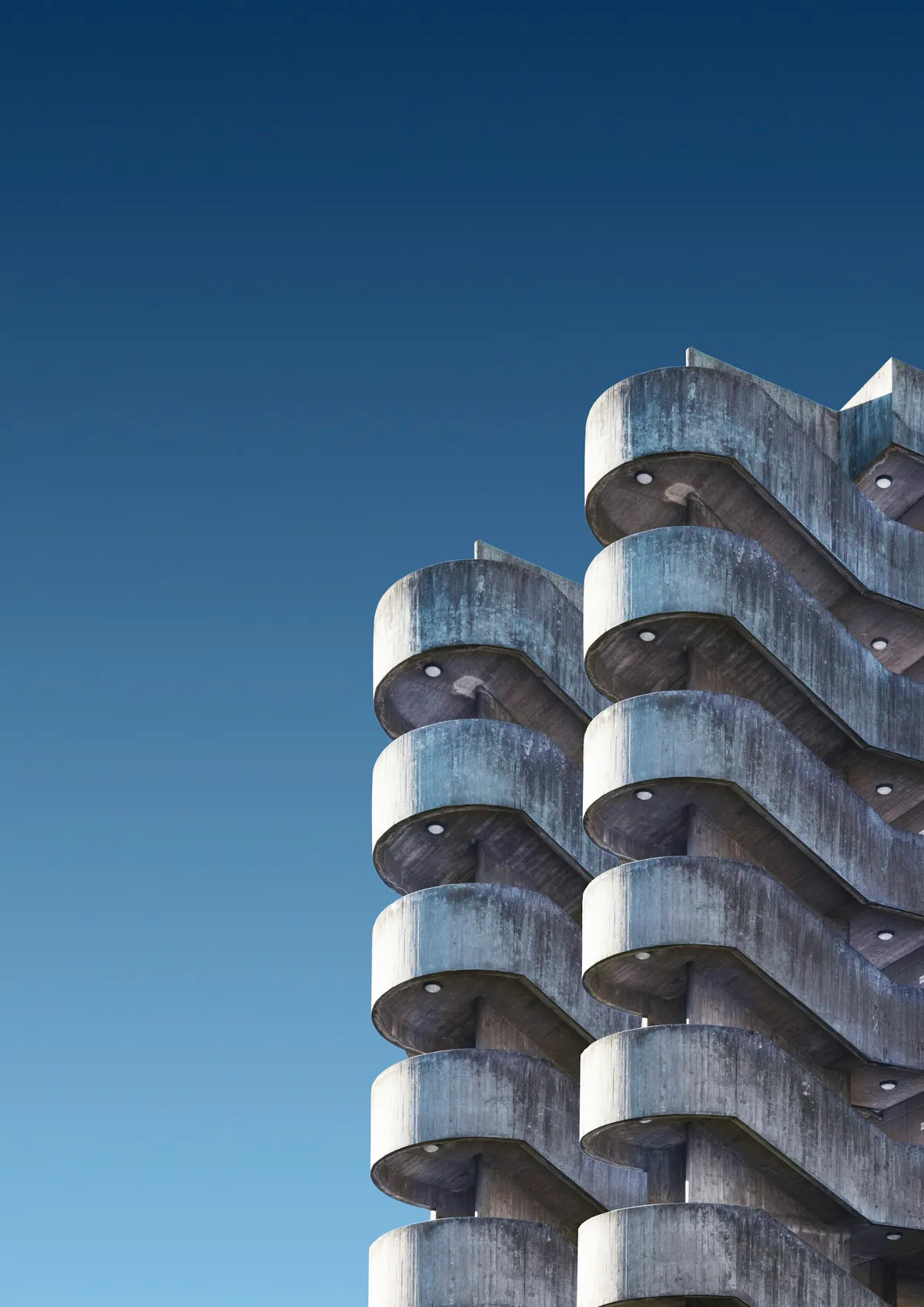 Close view of a tower facade built from repeated capsule modules with round windows