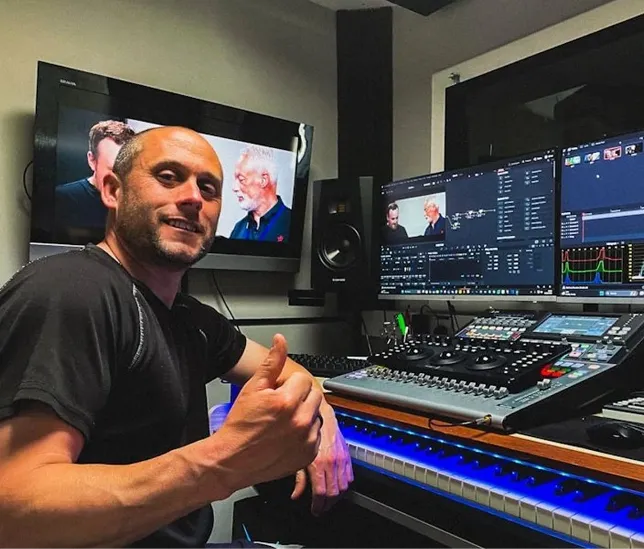 man posing for a picture in a computer room