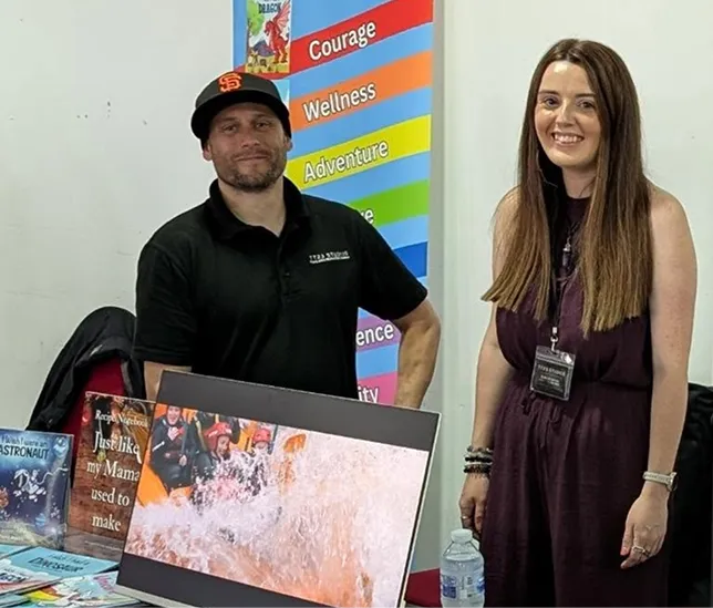 man and woman posing for picture in a room