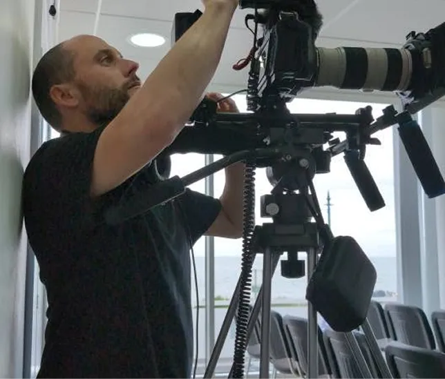 man recording a video with professional camera