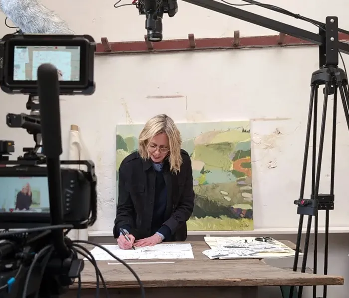 woman writng on a paper in a studio