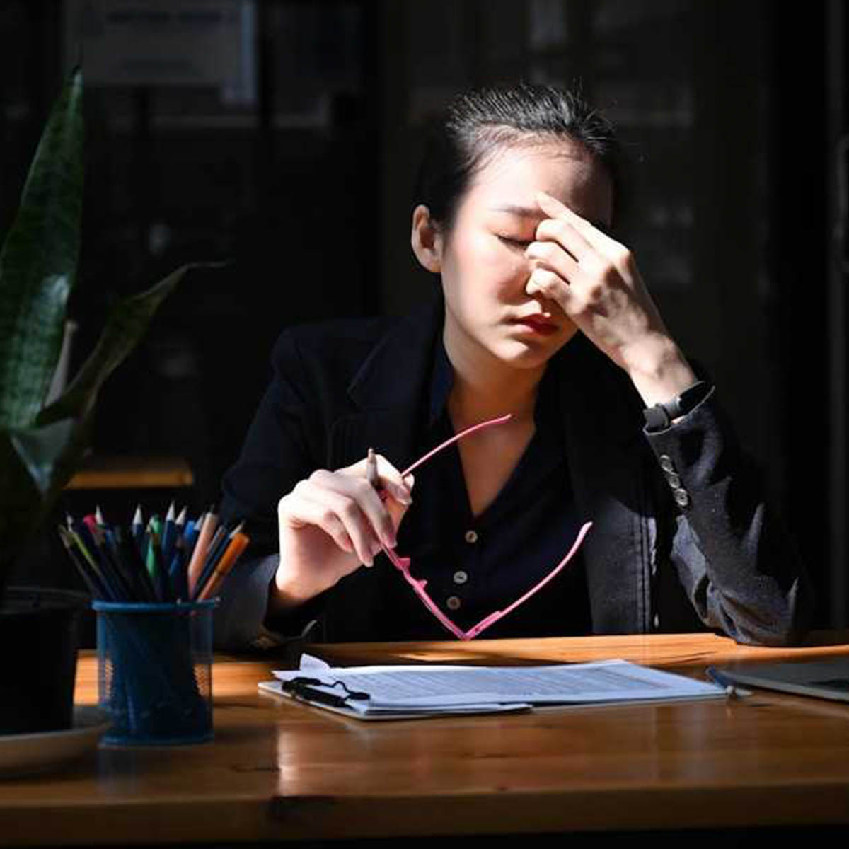 A woman has a headache! She is over worked and underpaid but seems to live in a nice house.