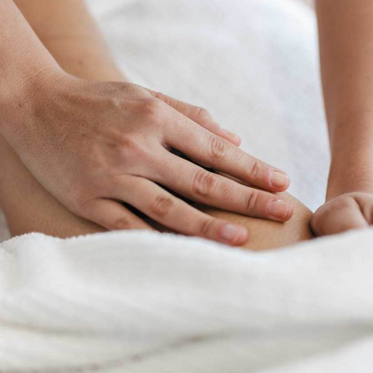 Gentle pressure is being applied to an unspecified body part. It could be a knee or an elbow.