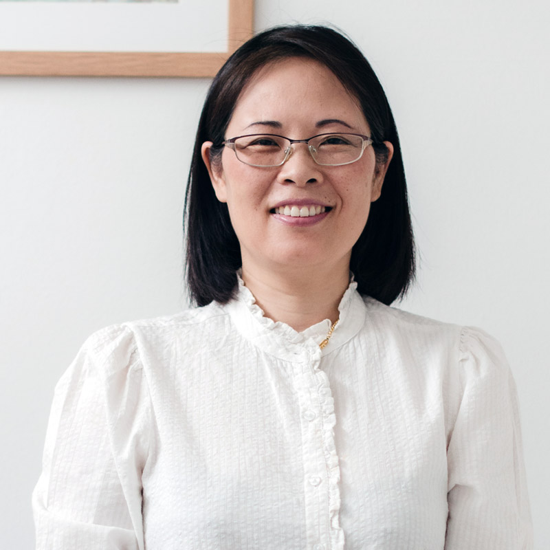 Acupuncturist smiling at the camera.