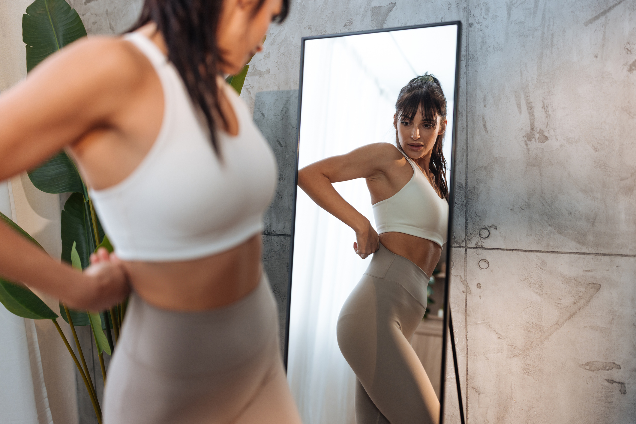 Woman looking at her reflection in a mirror