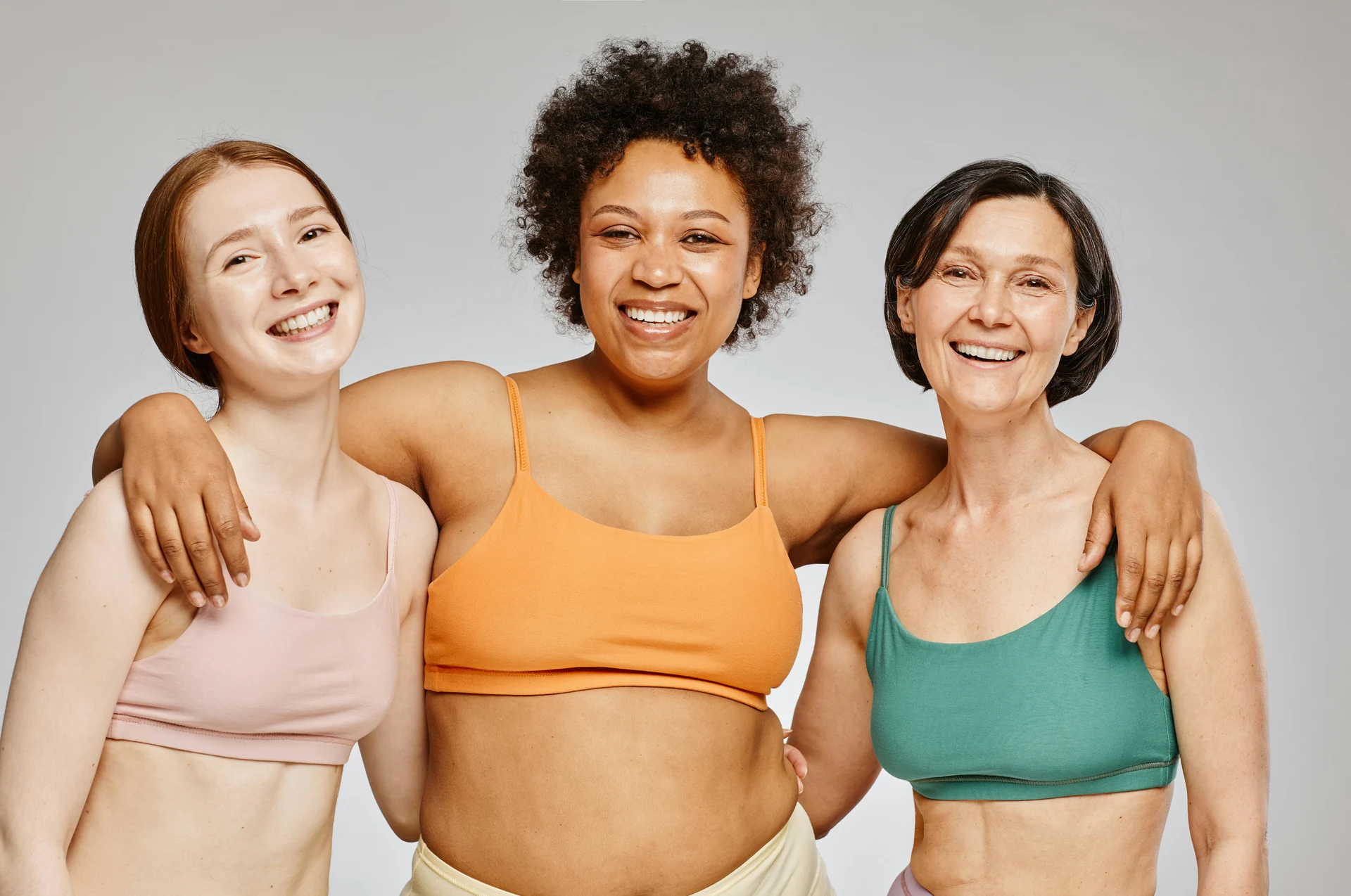Three women standing together in training clothes