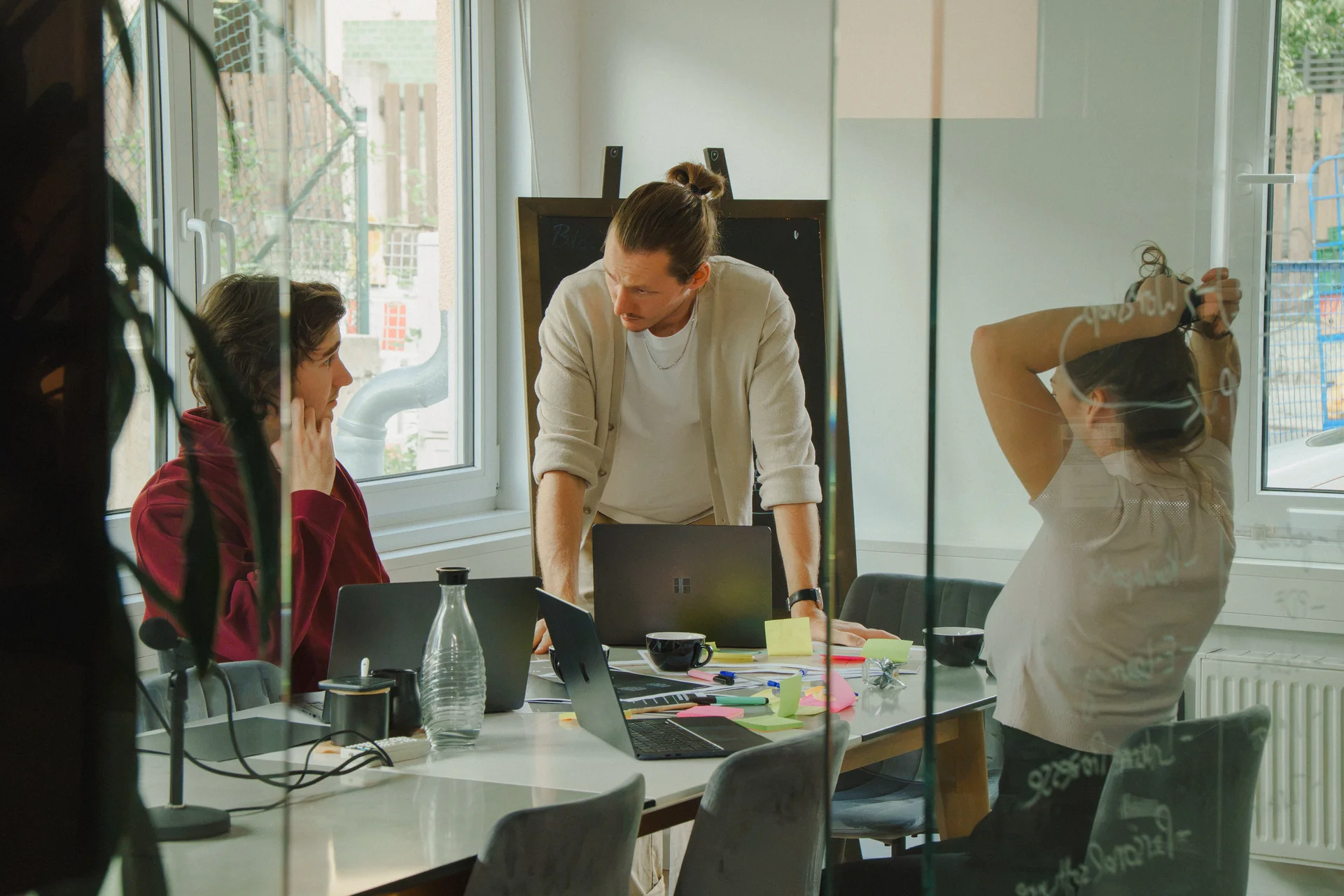 Team arbeitet gemeinsam an Laptops und Notizen im Büro