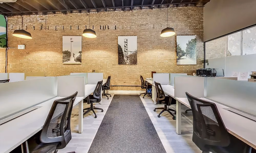 A sleek and modern dedicated desk setup in Chicago with personal touches and professional equipment for the best coworking spaces.
