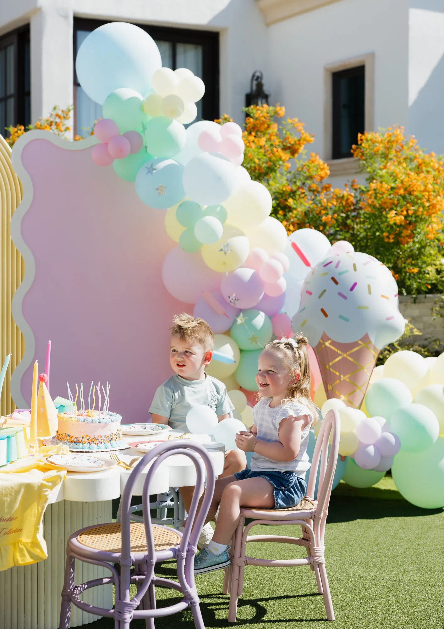Two children at an ice-cream themed birthday table
