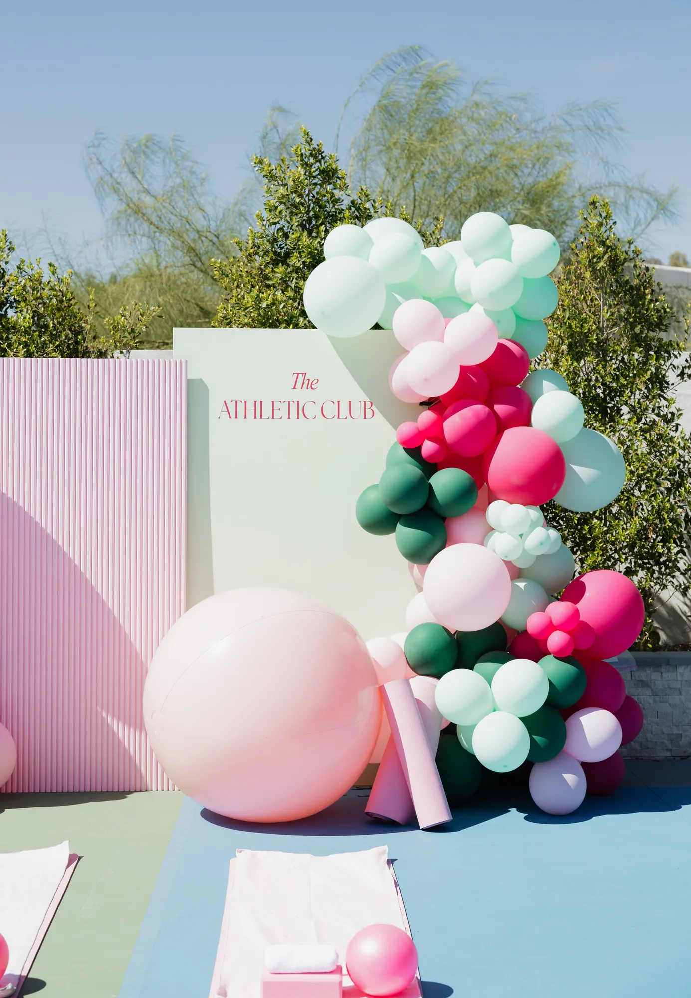 Mint, pink and green balloon garland against The Athletic Club backdrop