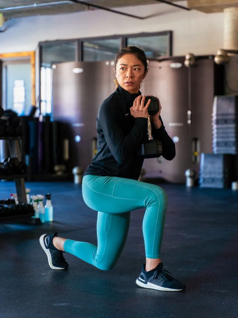 Aretha doing dumbbell split squats.