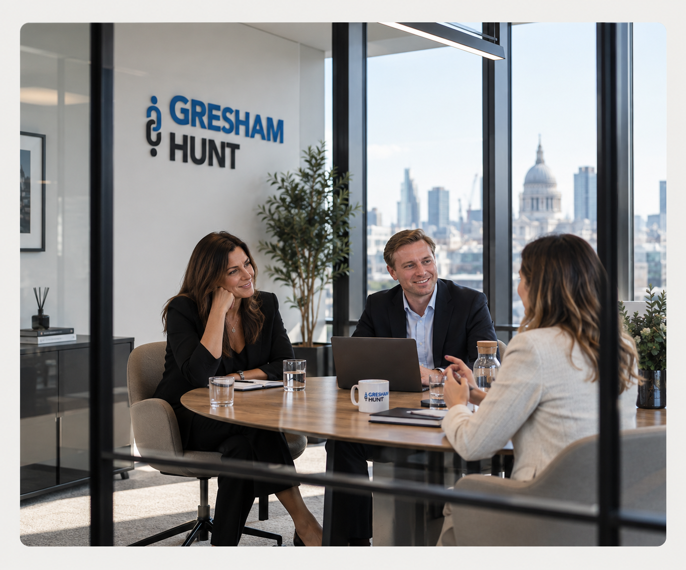 Gresham Hunt team around a table in London skyline