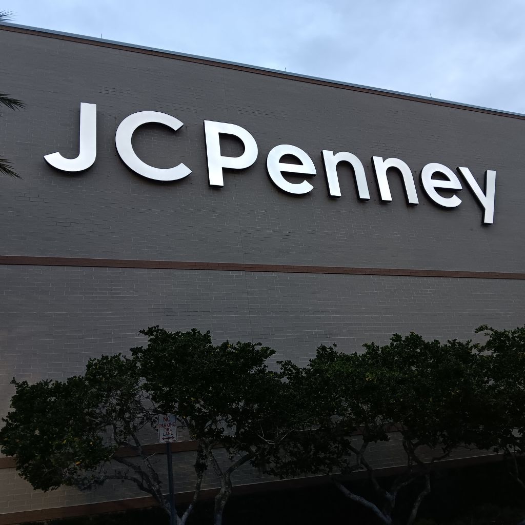 JCPenney exterior channel letter sign mounted on grey brick retail facade