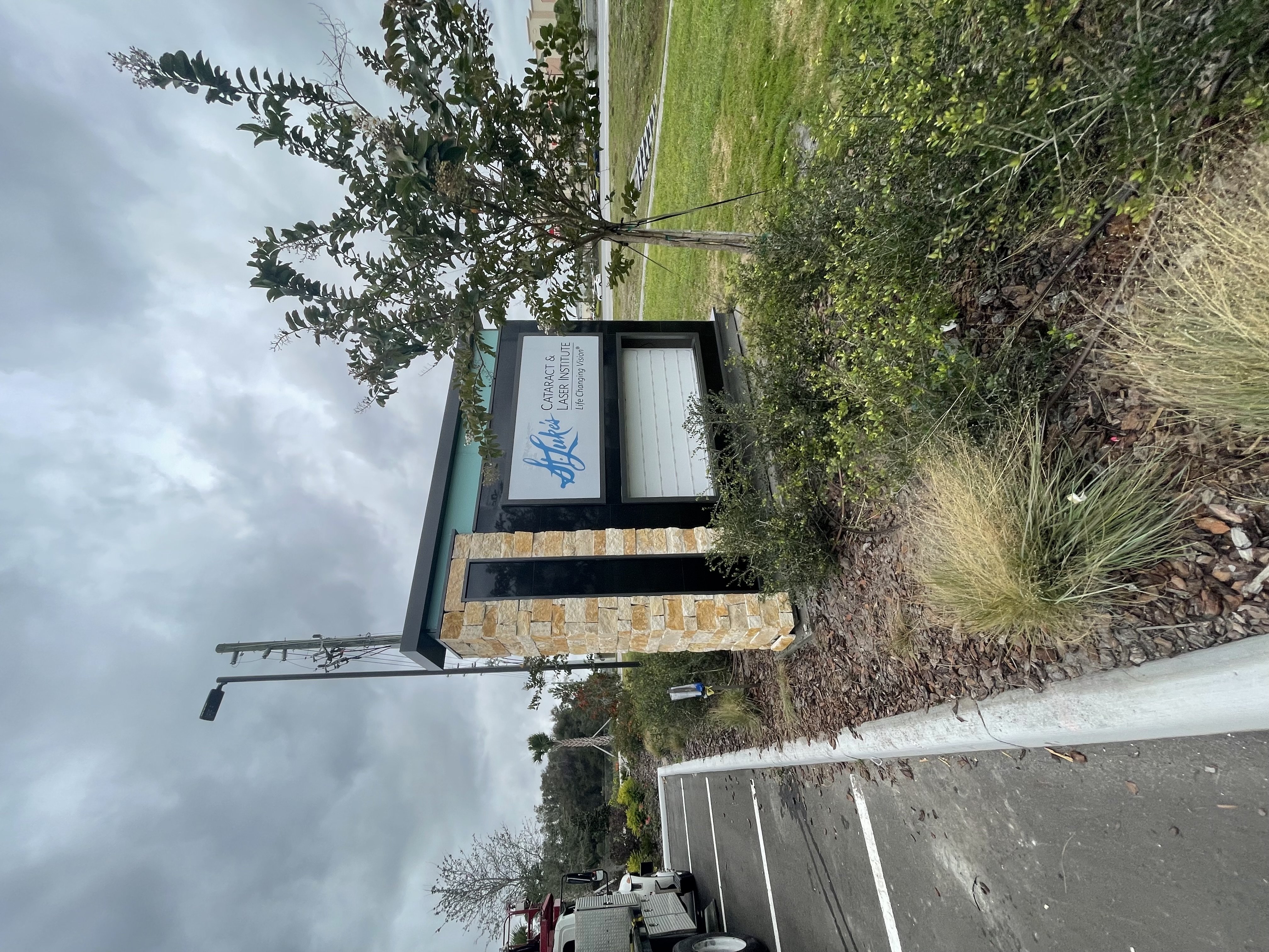 Finished St. Luke's Cataract & Laser Institute monument sign with stone pillar and lightbox